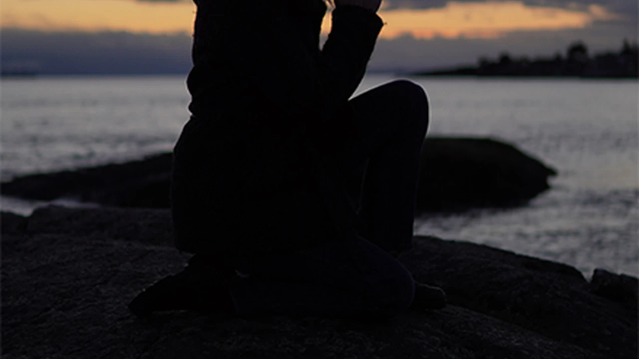 overhead view of corned beef sliced and on a platter with cabbage, potatoes, and carrots