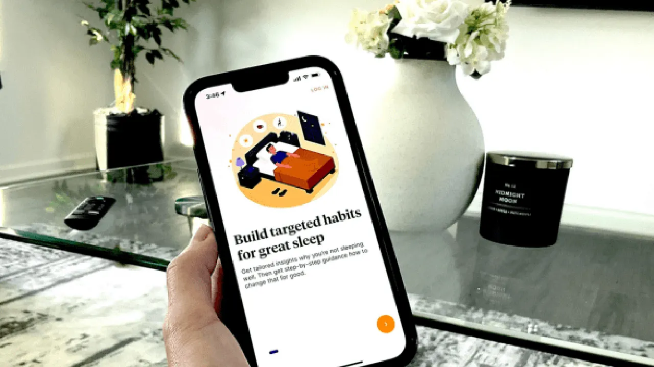 Close up on a plate of mashed potatoes, topped with baked pork chops with cream of mushroom soup, and a side of green beans.