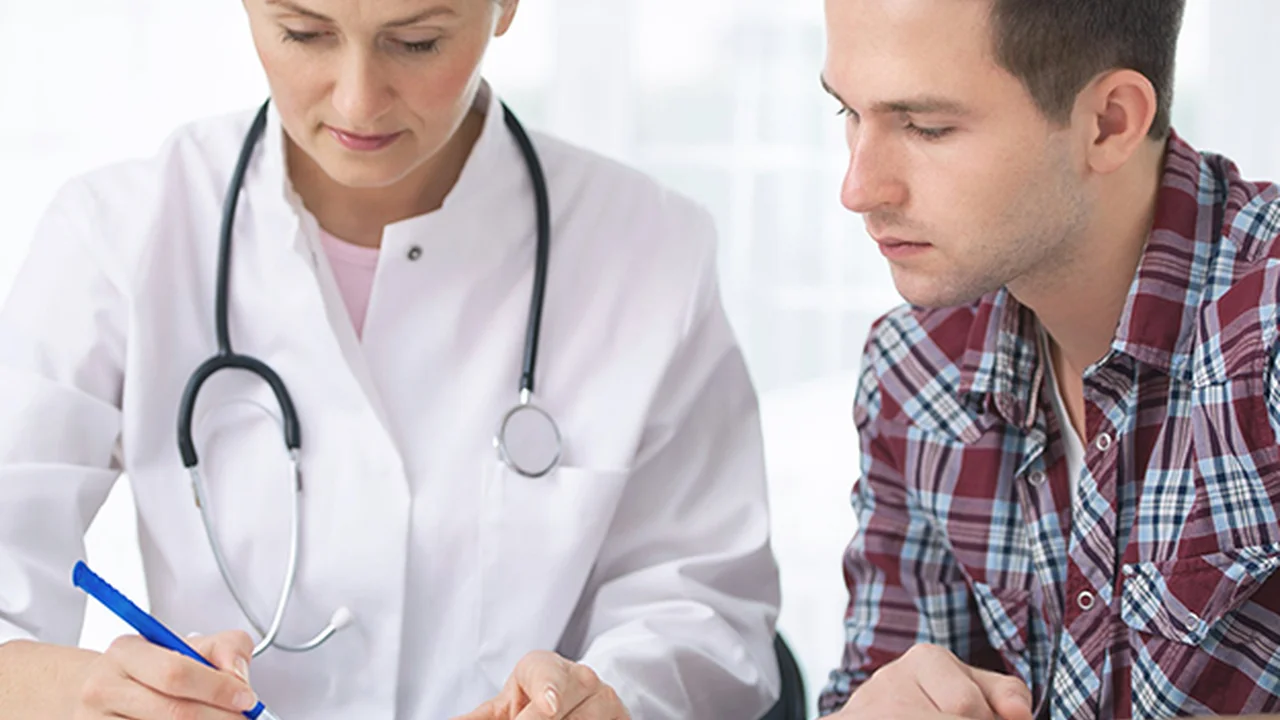 Close up on a plate of mashed potatoes, topped with baked pork chops with cream of mushroom soup, and a side of green beans.